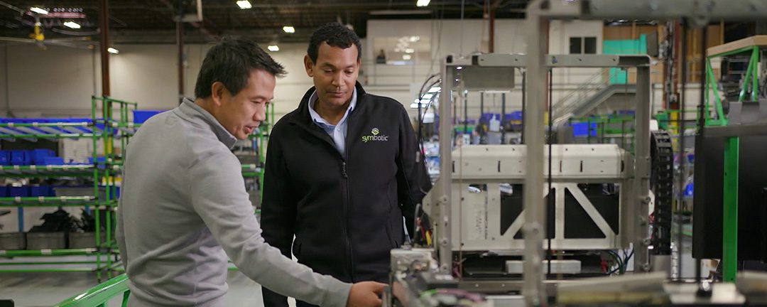 Symbotic engineers working together on robot systems